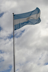 Argentine flag flying on cloudy day