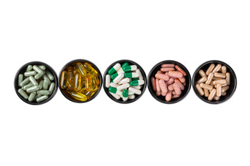 Vitamins and supplements. Variety of vitamin tablets isolated on a white background. Multivitamin complex for every day. Nutritional supplements. Time to drink pills.