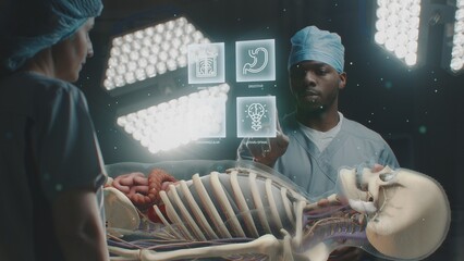 Diverse surgeons work in operating room. African American doctor talks with colleague, uses virtual...