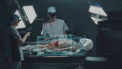 Male and female surgeons in AR headsets perform surgery in operating room using AI. Virtual...