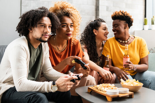 Brazilian friends gathered at home have fun in the living room