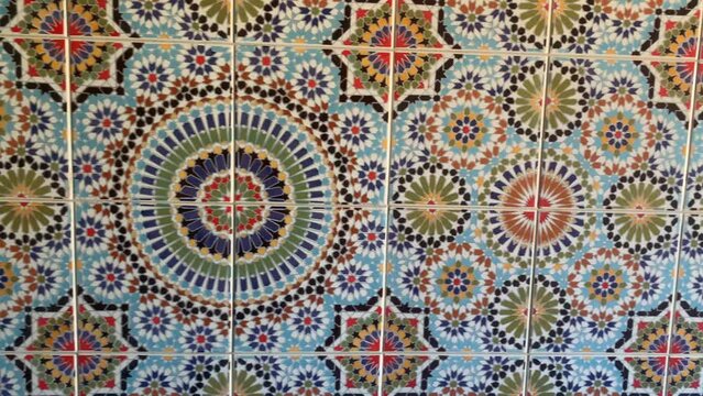 Colorful zellige tiles of a mosque in Morocco. Mosaic pattern, traditional Islamic geometric design. Moroccan craft, handmade. 4k footage.
