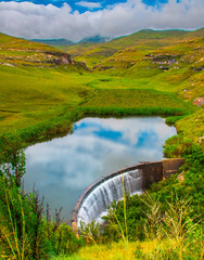 Langtoon Dam nestled in a valley in the Golden Gate Highlands National Park beneath the distant...