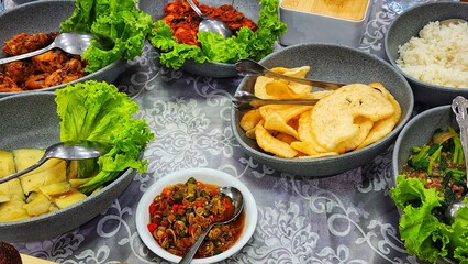 a table with bowls of food and utensils