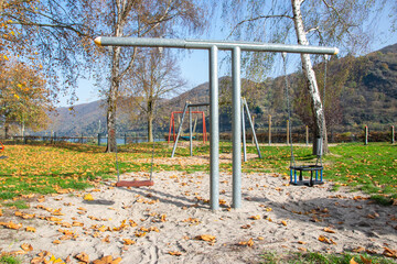 Fototapeta na wymiar Playground for children, swings on the street.
