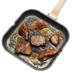 pieces of Organic grilled Tuna Steak on a grill frying pan isolated