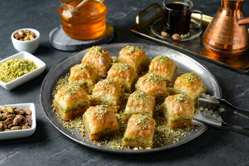 Delicious fresh baklava with chopped nuts served on grey table. Eastern sweets