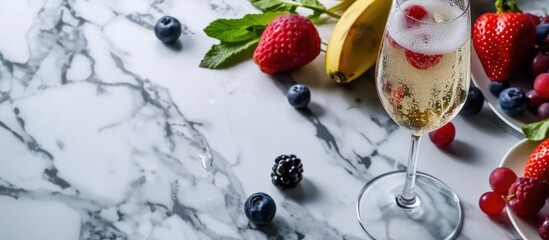 Champagne drink with fresh fruit in empty space on marble table. - obrazy, fototapety, plakaty