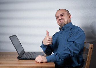 Mature businessman with laptop at his desk