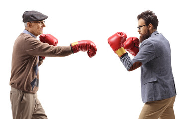 Elderly and younger man fighting with boxing gloves