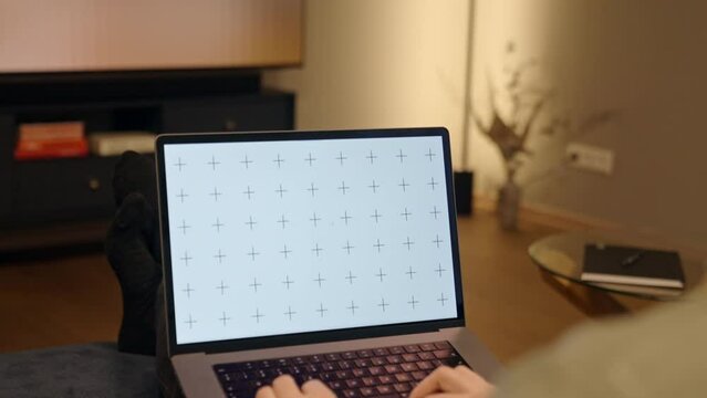 Close up of a male working from home office, typing or browsing application or website on laptop mockup, cozy home workspace, home office