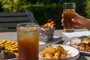 Food and glasses of ice tea on the table