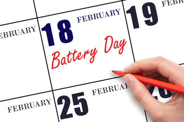 February 18. Hand writing text Battery Day on calendar date. Save the date.