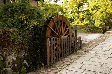 Water wheel at streets and traditional Japanese houses at Magome Juku town along the Nakasendo trail in Kiso Valley, Japan.