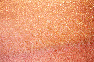 Christmas holiday glittering defocused Peach Fuzz background with bokeh lights