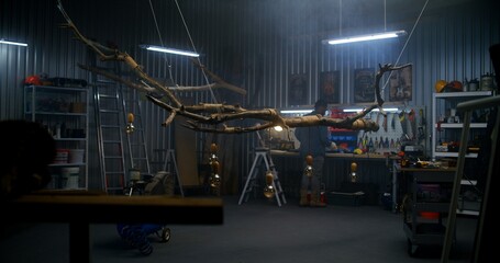 African American carpenter ties with rope design wood product from tree branch with light bulbs. Artisan or designer woodworking in modern garage or workshop. Hand craft and entrepreneurship concept.