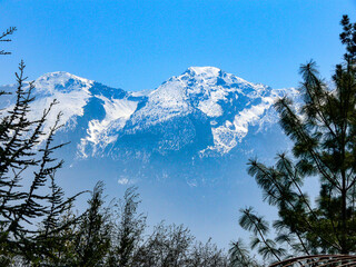 The snow-covered peaks of the Monte Baldo mountain range on Lake Garda in bright sunshine
