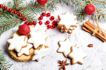 Traditional Christmas glazed gingerbread cookies in the shape of a star. Cookies for the holiday. New Year's decor. White background