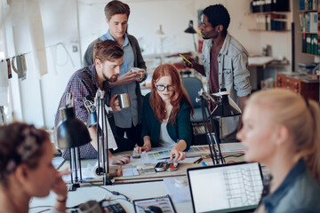 Diverse young architects working in modern office