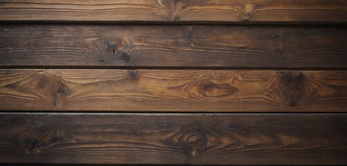 This image shows a close-up view of a wooden surface, characterized by horizontal planks with visible grains and textures. The wood has a dark brown color, and the lines between the planks are clearly