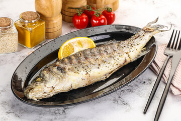 Grilled sea bass fish served lemon