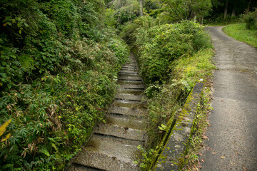 Walking the hiking road following the Nakasendo trail between Tsumago and Magome in Kiso Valley, Japan.