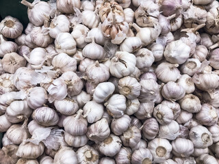 Garlic in a box ,vegetable for food whole white ,lying in a drawer in supermarket .concept healthy food vitamins for cold