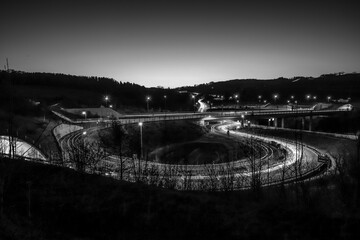 long exposure black and white photography of an round highway entrance during night