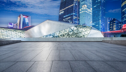 Empty square floor and city buildings landscape at night