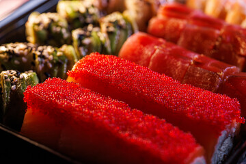 A set of delicious sushi rolls Close-up of sushi rolls with caviar and salmon
