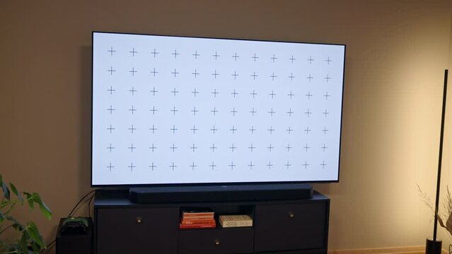 TV screen mockup in cozy living room, television mockup with free copy space, warm light, moody lighting