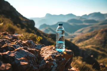 Rolgordijnen Glass water bottle in the middle of nature on the mountain © ORG