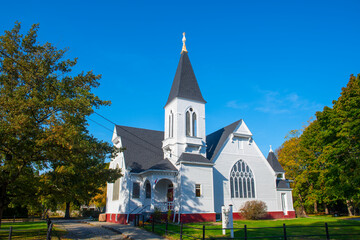 Fototapeta na wymiar Restoration Community Church with fall foliage at 211 Main Street, in historic town center of Kingston, Massachusetts MA, USA.