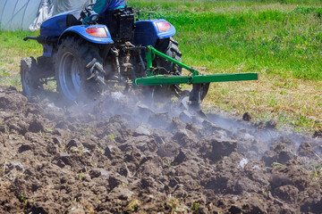 In autumn, tractors plow land in preparation for spring season