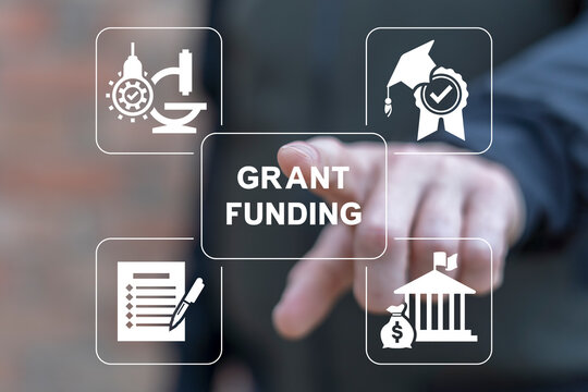 Man using virtual touchscreen presses inscription: GRANT FUNDING. Concept of business, education grants funding. Innovation Grant Fund Application Donation.