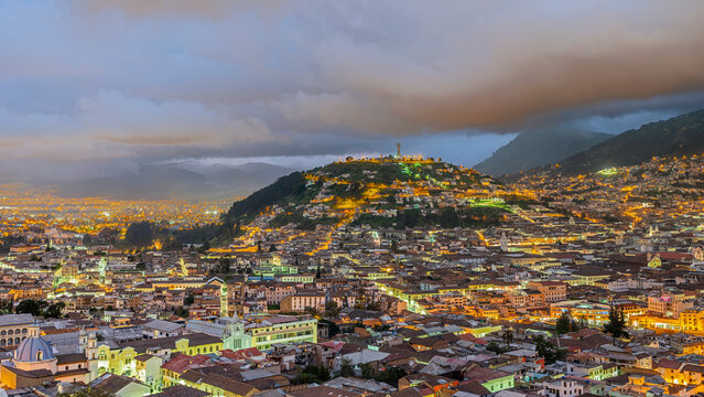Panecillo hill Virgen of Quito statue and old colonial center of Quito at blue hour
