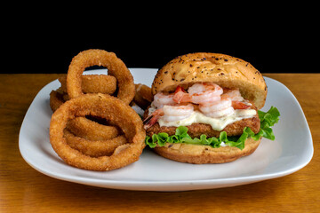 fish sandwich  top with tarter sauce and shrimp