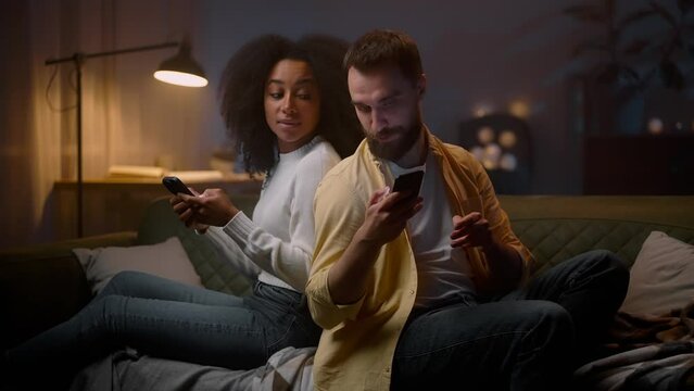 Internet addicted pair gadgets holding at sofa