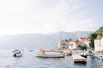 Boats are moored at the pier of the ancient town of Perast. Montenegro