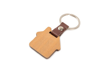 Keychain in the shape of a house with a key ring isolated on a white background. Concepts for real estate and moving home or renting property. Buying a property. Mock-up keychain house shaped.
