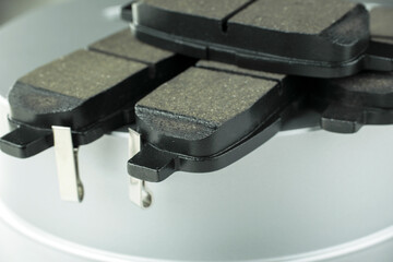 The brake pads are black for the car, the pads lie on the brake discs for the car.