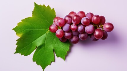 Red grapes with green leaves and half sliced isolated on white background.