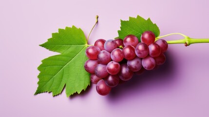 Red grapes with green leaves and half sliced isolated on white background.