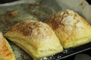 Folded baked puff pastry pies portions, top view