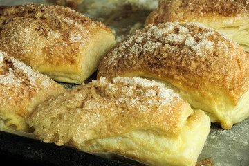 Folded baked puff pastry pies portions, top view