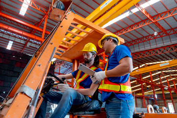 Side view of Caucasian worker sit in factory truck and discuss about work with his co-worker hold...