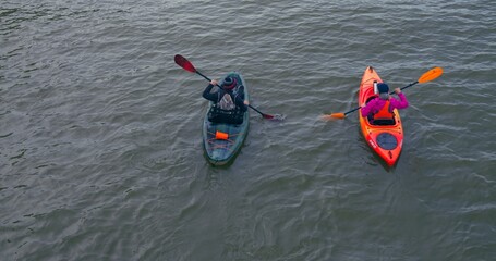 Two people in kayaks glide over Lake Ontario top view cinematic shot. Leisure on Lake Ontario with kayaks healthy lifestyle Kayaks sport training tourist events mental rejuvenation nature with unity.