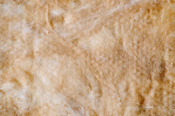 Background of yellow glass wool, texture of insulation material close-up