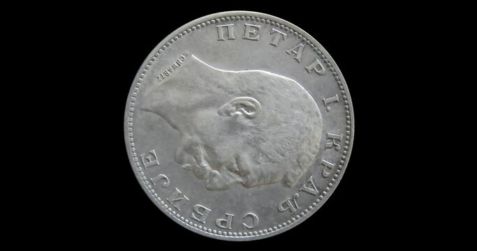 Obverse of Serbia coin 2 dinara 1912 with portrait of king Petar I, isolated in black background. 3d animation in 4k video.