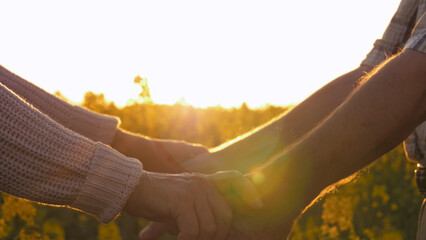 Close up of arms parting elderly people. Touching gesture separation of couple old spouses. They...